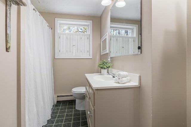 bathroom featuring baseboard heating, toilet, vanity, and a healthy amount of sunlight