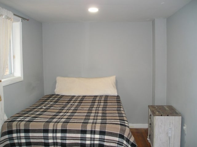 bedroom with dark hardwood / wood-style floors