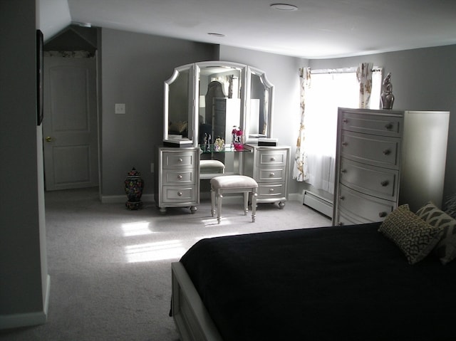 carpeted bedroom featuring baseboard heating