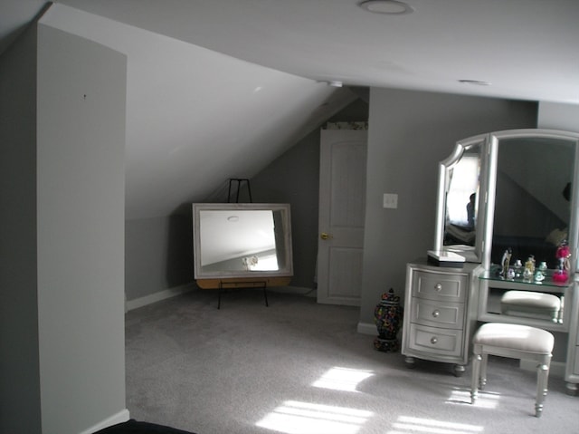 bonus room featuring lofted ceiling and carpet