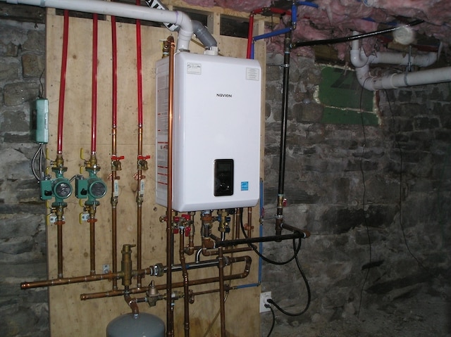 utility room featuring water heater