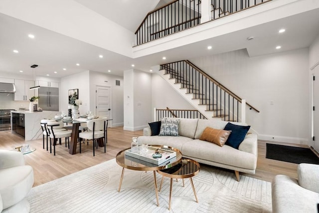 19 Johnson Pl Unit 19, Newton, MA 02466 - living room with light wood finished floors, stairs, recessed lighting, baseboards, and a high ceiling