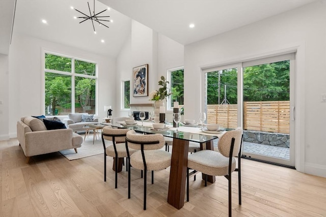 19 Johnson Pl Unit 19, Newton, MA 02466 - dining space featuring light wood-style flooring, high vaulted ceiling, baseboards, a chandelier, and recessed lighting