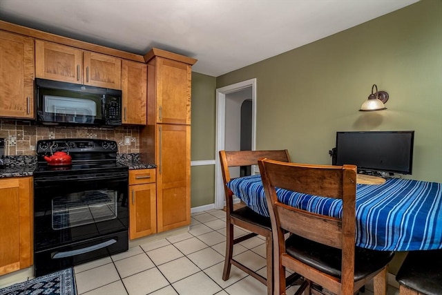 80 Andover, Peabody, MA 01960 - kitchen featuring light tile patterned floors, brown cabinets, black appliances, and backsplash