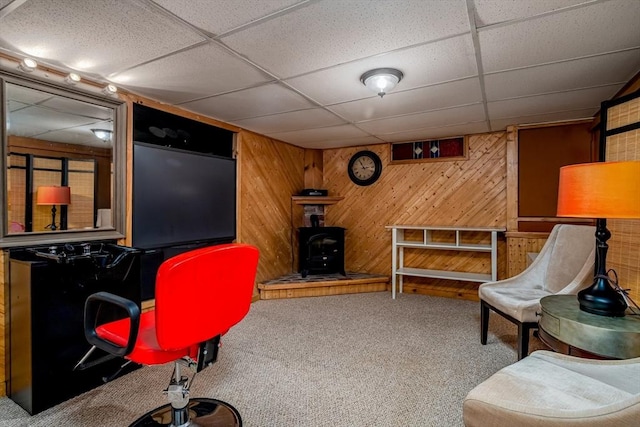 80 Andover, Peabody, MA 01960 - home office featuring wooden walls, a wood stove, a drop ceiling, and carpet