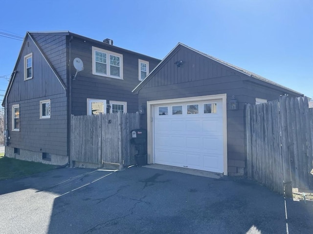 80 Andover, Peabody, MA 01960 - view of front facade with aphalt driveway, fence, and an outbuilding