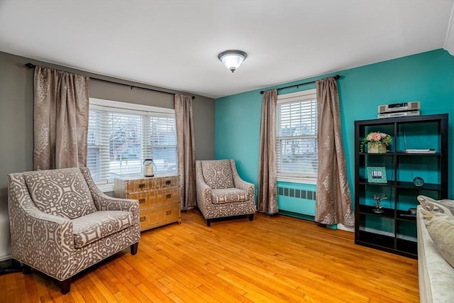 80 Andover, Peabody, MA 01960 - sitting room with radiator heating unit and light wood finished floors