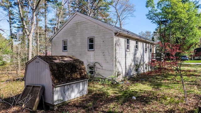 view of home's exterior featuring an outbuilding and a shed