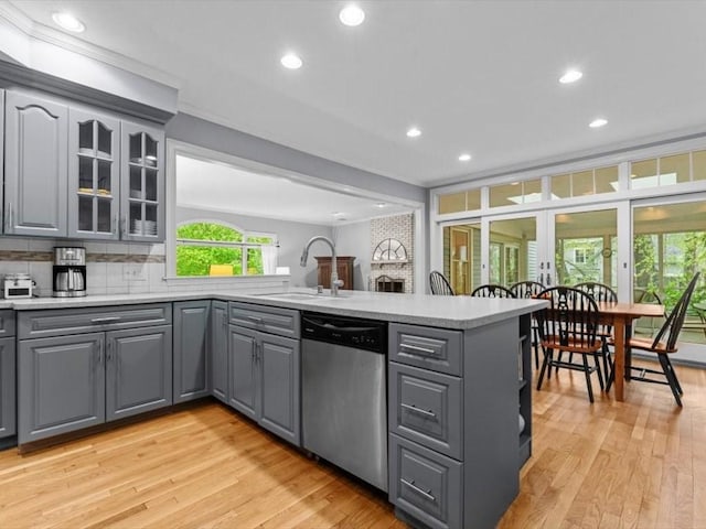 kitchen featuring stainless steel dishwasher, gray cabinets, a peninsula, a sink, and recessed lighting
