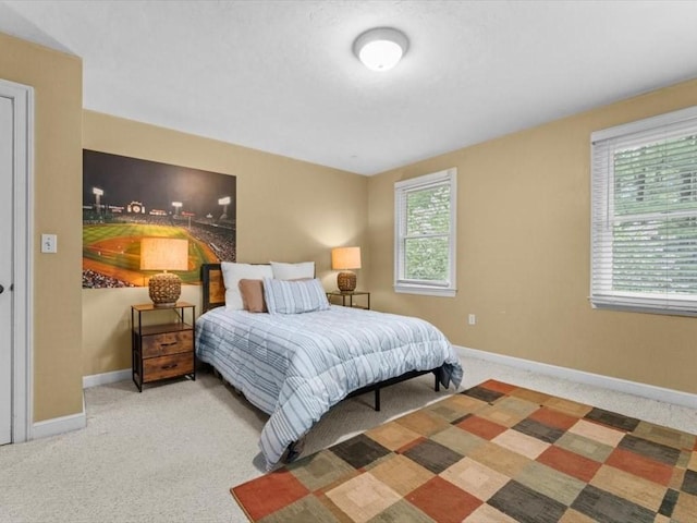 carpeted bedroom featuring baseboards
