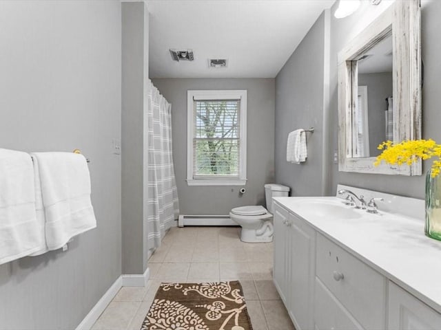 bathroom with a baseboard radiator, toilet, vanity, tile patterned flooring, and baseboards