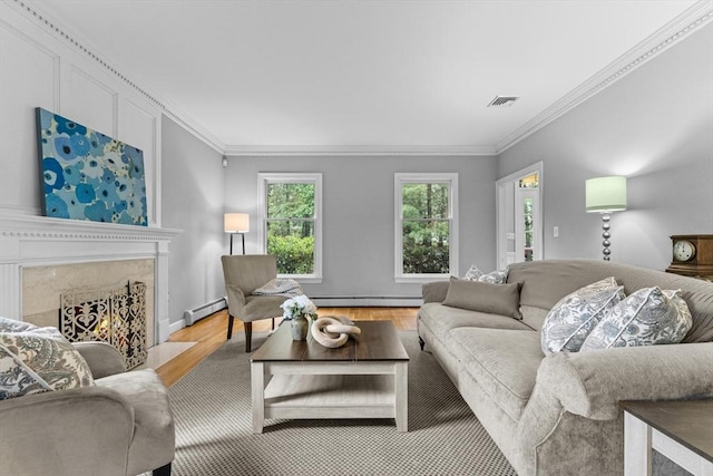 living room featuring crown molding, wood finished floors, baseboard heating, a baseboard radiator, and a high end fireplace