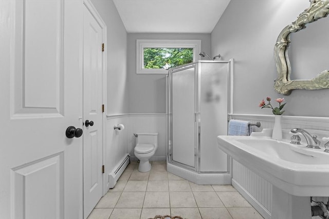full bathroom featuring a baseboard radiator, a shower stall, a sink, toilet, and a wainscoted wall
