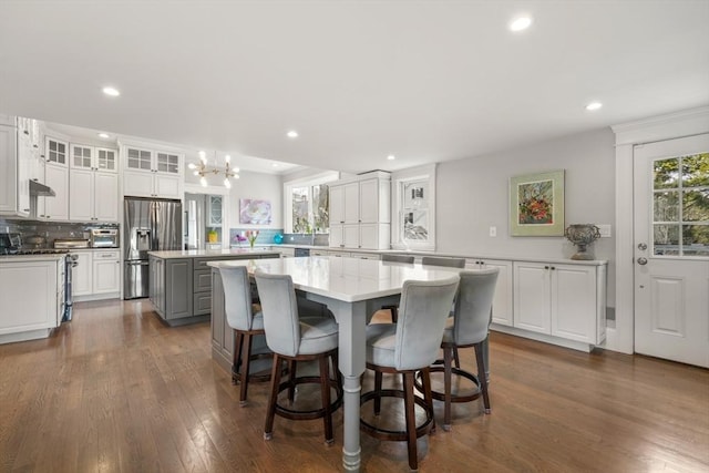 dining room featuring an inviting chandelier, dark wood finished floors, and recessed lighting