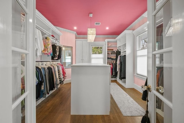 spacious closet featuring visible vents and wood finished floors