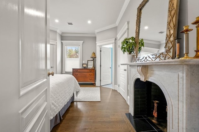bedroom featuring recessed lighting, visible vents, ornamental molding, and dark wood-style floors