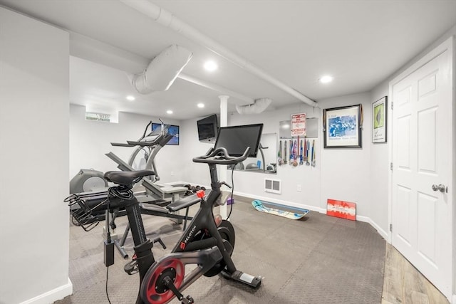 workout area featuring baseboards, visible vents, and recessed lighting