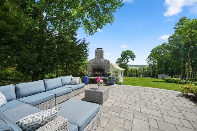 view of patio featuring an outdoor living space with a fireplace