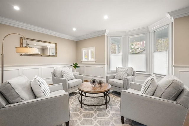 living area featuring crown molding, a wealth of natural light, and a decorative wall
