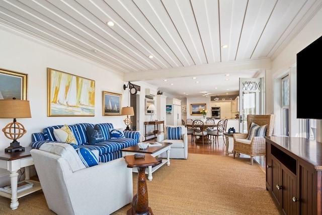 living room with crown molding and light hardwood / wood-style flooring