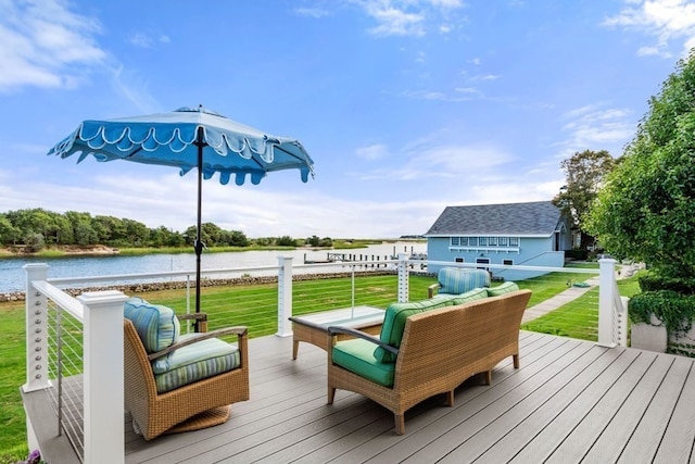 wooden terrace with a water view and a yard