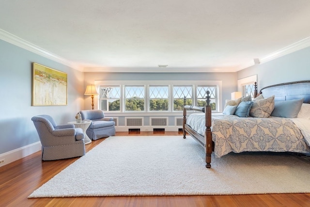 bedroom with crown molding and hardwood / wood-style floors