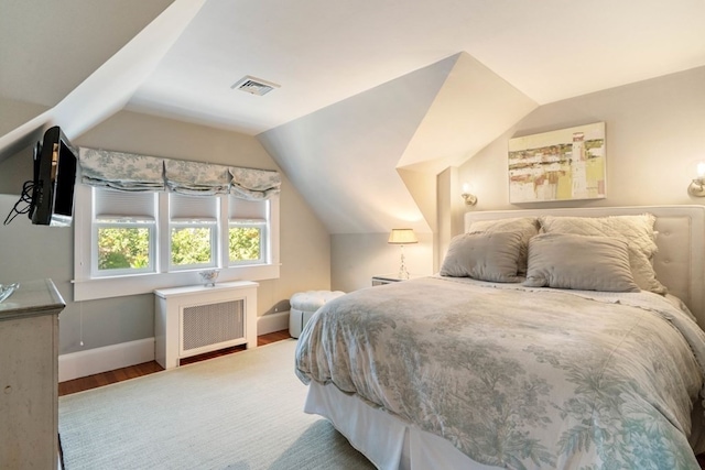 bedroom with lofted ceiling and dark hardwood / wood-style flooring