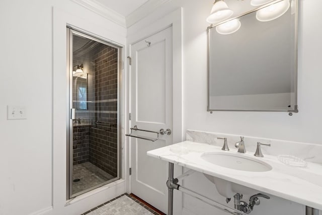 bathroom with a shower with shower door, ornamental molding, and vanity