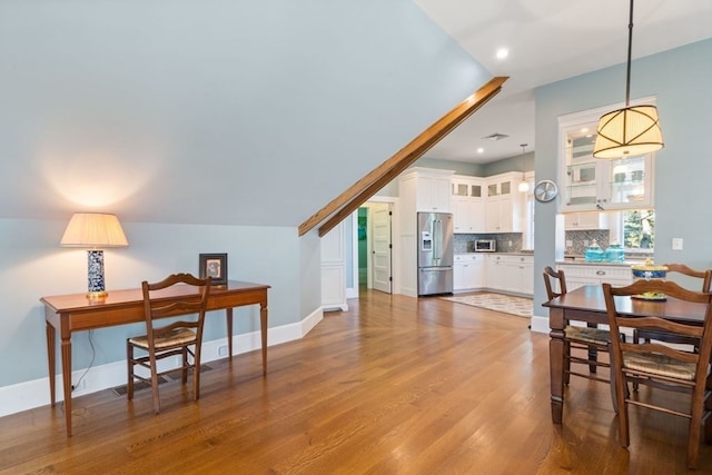 dining space with light hardwood / wood-style floors