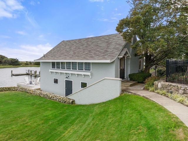 exterior space with a water view and a yard