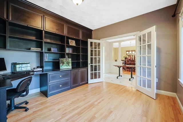 office with light wood-type flooring, french doors, baseboards, and a chandelier