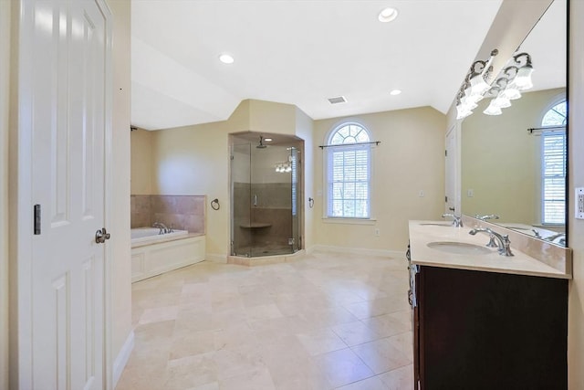 bathroom with a healthy amount of sunlight, a shower stall, and a sink