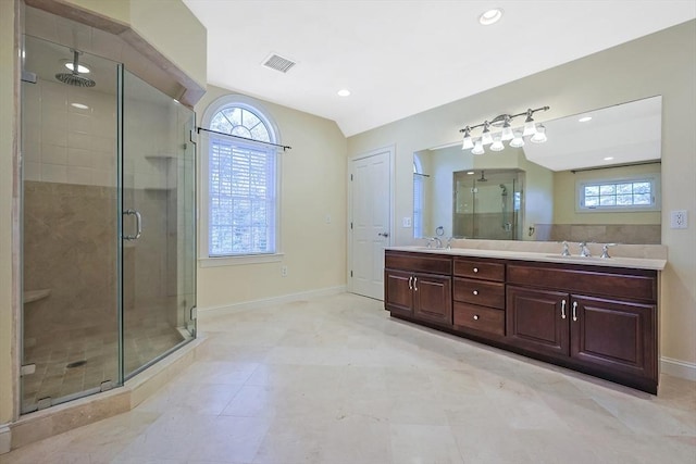 bathroom featuring a stall shower, visible vents, a wealth of natural light, and a sink