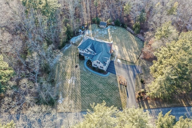 birds eye view of property with a forest view