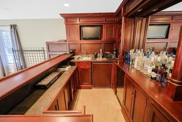 bar featuring dishwasher, light tile patterned floors, recessed lighting, wet bar, and a sink