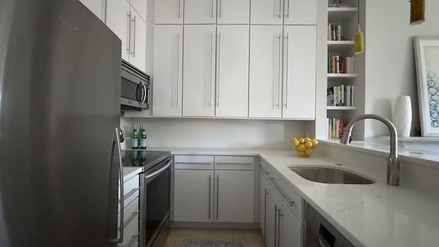 kitchen featuring open shelves, stainless steel appliances, light tile patterned flooring, white cabinetry, and a sink