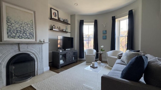 living room with a fireplace and baseboards