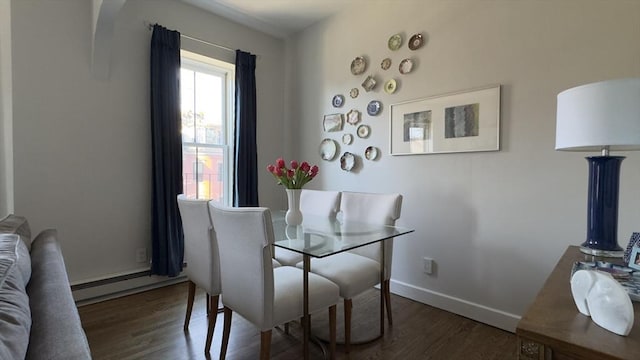 dining space with wood finished floors and baseboards