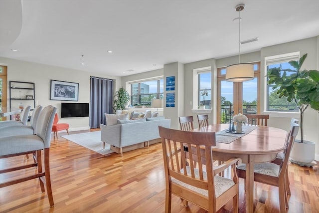 dining area with light wood-style floors, visible vents, and recessed lighting