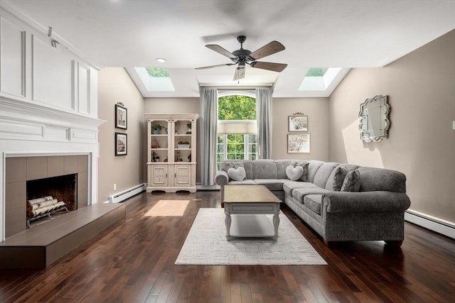 267 W St, Northborough, MA 01532 - living room with a skylight, a baseboard heating unit, ceiling fan, dark wood-style flooring, and vaulted ceiling