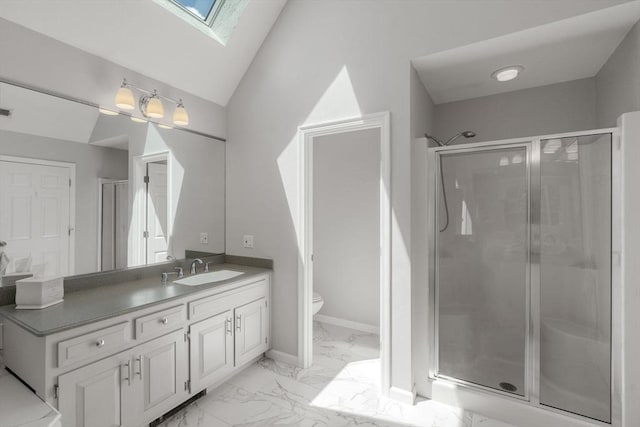 267 W St, Northborough, MA 01532 - bathroom featuring a skylight, marble look tiles, a stall shower, vanity, and toilet