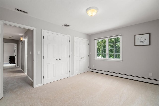 267 W St, Northborough, MA 01532 - unfurnished bedroom with carpet floors, multiple closets, a baseboard radiator, and baseboards