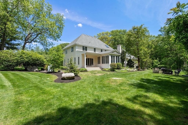 267 W St, Northborough, MA 01532 - rear view of house with a chimney and a lawn