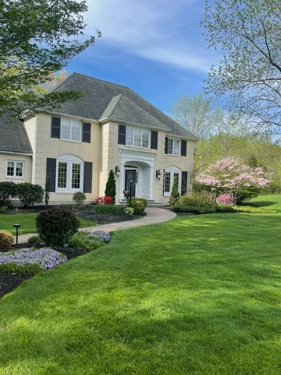 267 W St, Northborough, MA 01532 - georgian-style home with a front yard and a shingled roof