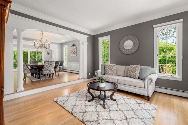 267 W St, Northborough, MA 01532 - living area featuring ornate columns, a chandelier, a baseboard heating unit, plenty of natural light, and crown molding