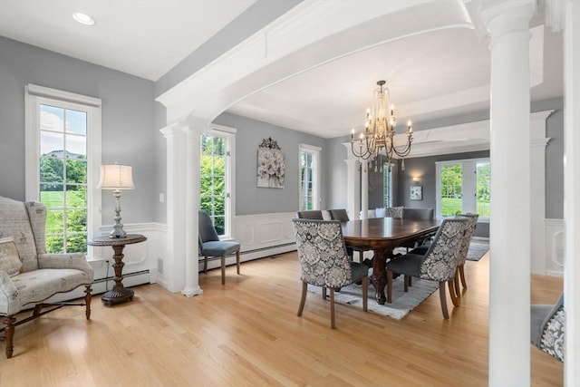 267 W St, Northborough, MA 01532 - dining space featuring decorative columns, plenty of natural light, a wainscoted wall, light wood finished floors, and a decorative wall