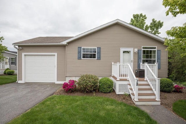 18 Skyview Dr, Brockton, MA 02301 - view of front of home with an attached garage and asphalt driveway