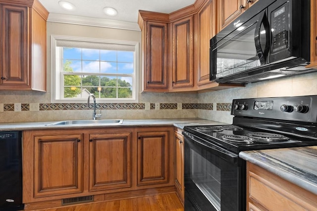 18 Skyview Dr, Brockton, MA 02301 - kitchen featuring black appliances, a sink, brown cabinets, and crown molding