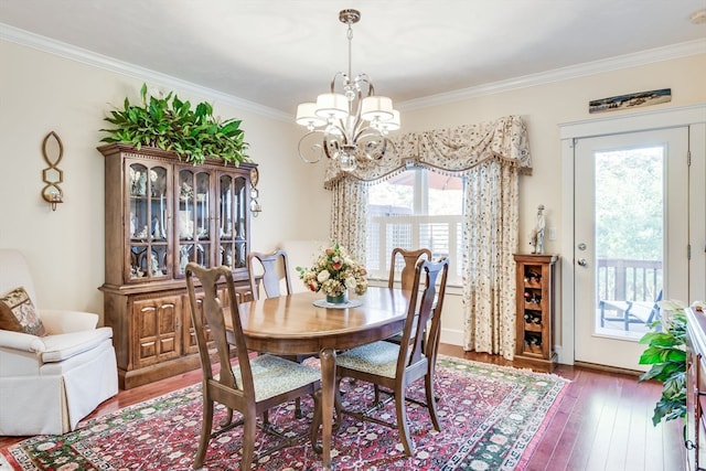 dining room with crown molding, a chandelier, and dark hardwood / wood-style floors