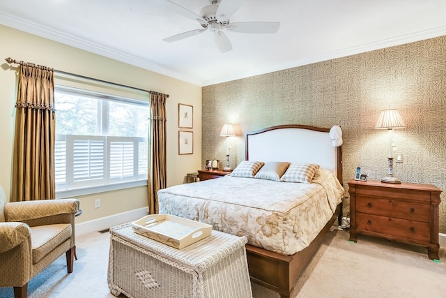 carpeted bedroom with ceiling fan and ornamental molding